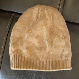 Knit Hat with gold tone accents.